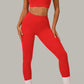 Striking red women's activewear, pilates, gym and yoga set with high-waisted leggings and fitted crop top.