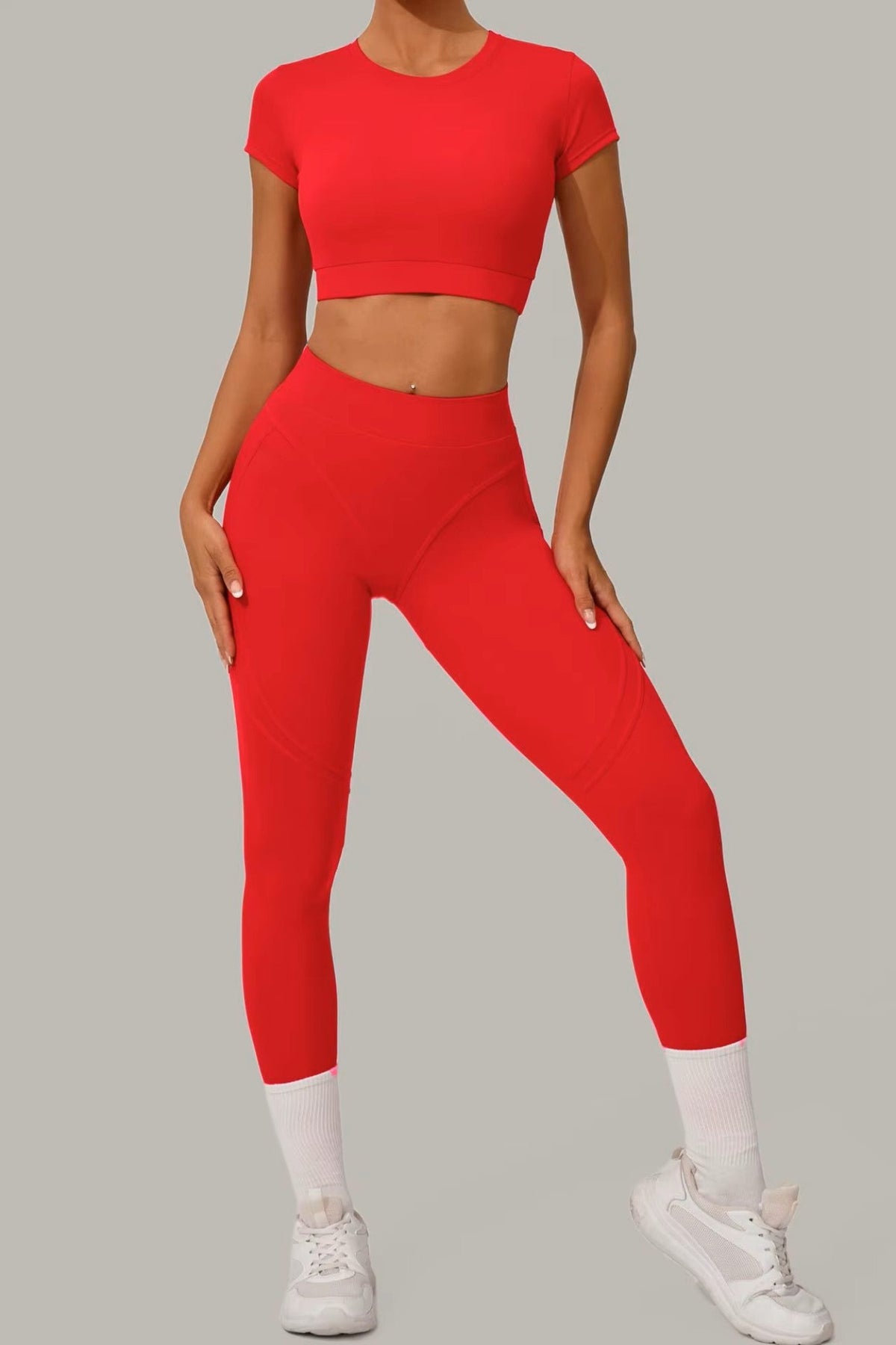 Striking red women's activewear, pilates, gym and yoga set with high-waisted leggings and fitted crop top.