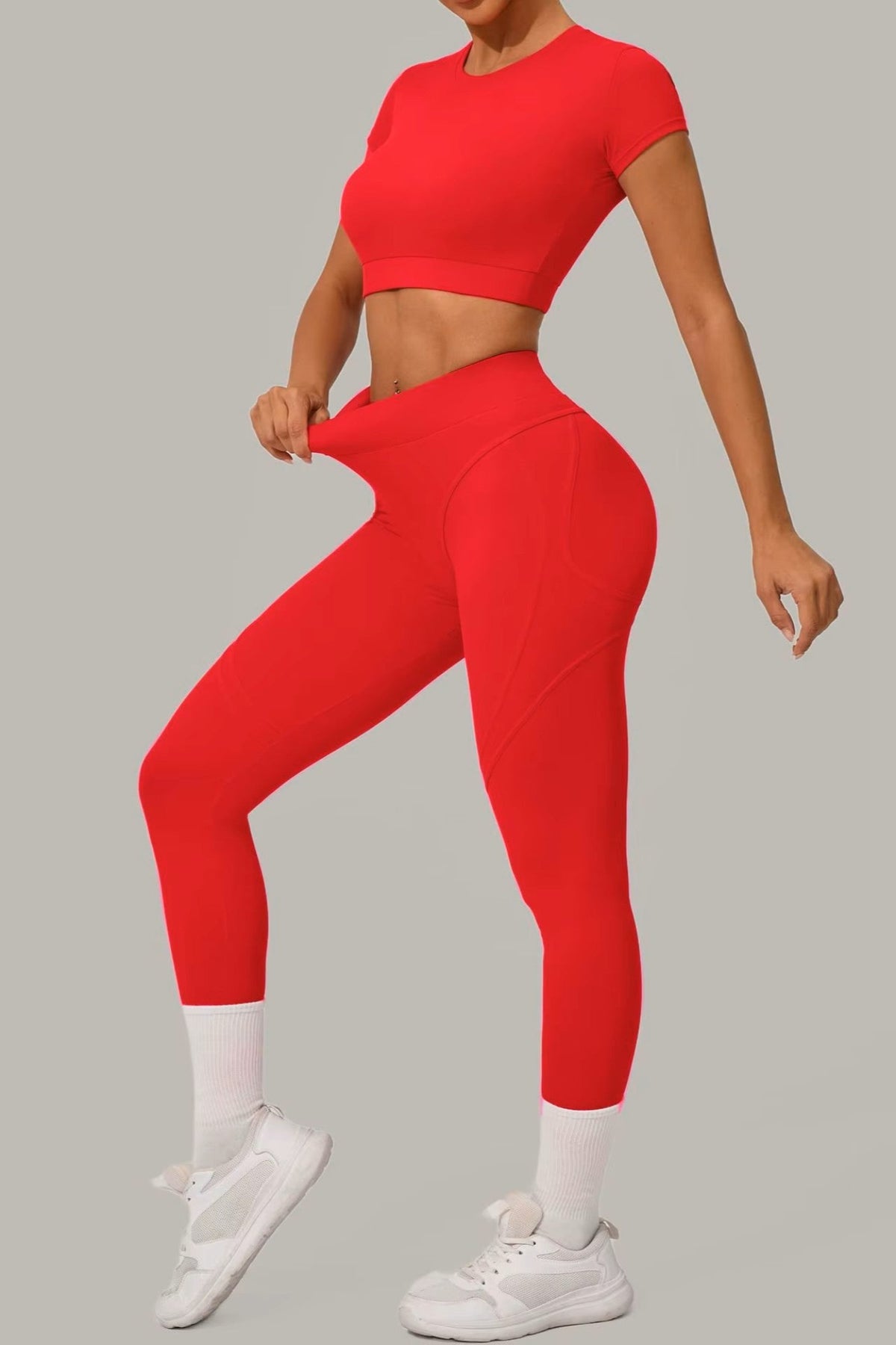 Striking red women's activewear, pilates, gym and yoga set with high-waisted leggings and fitted crop top.