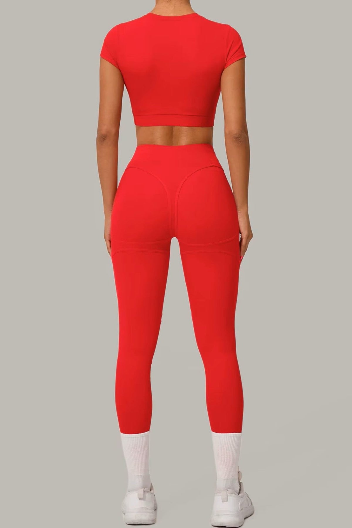 Striking red women's activewear, pilates, gym and yoga set with high-waisted leggings and fitted crop top.