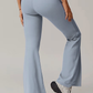 Light blue grey flared pants worn by a person on a plain background