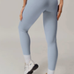 Light blue grey leggings worn by a person on a plain background
