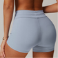 Light blue grey athletic shorts worn by a person on a neutral background